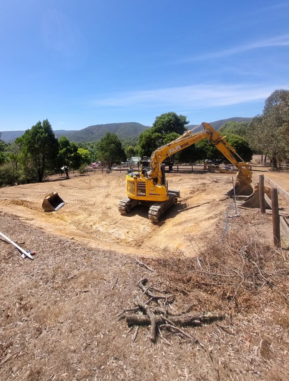 excavator cutting a level building pad on a rural block, earthworks, melbourne's north east